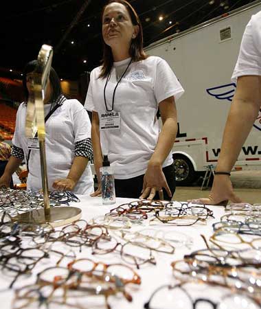 Volunteers wait at the prescription glasses table