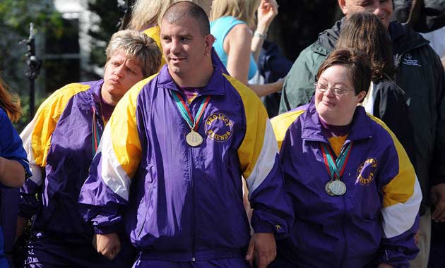 Members of the Special Olympics watch as the coffin of Eunice Kennedy Shriver is carried into St Francis Xavier Church 