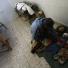Palestinian father Magdi al-Samuli mourns over the bodies of his children