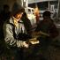 Palestinian boys pick up pages from a torn Koran