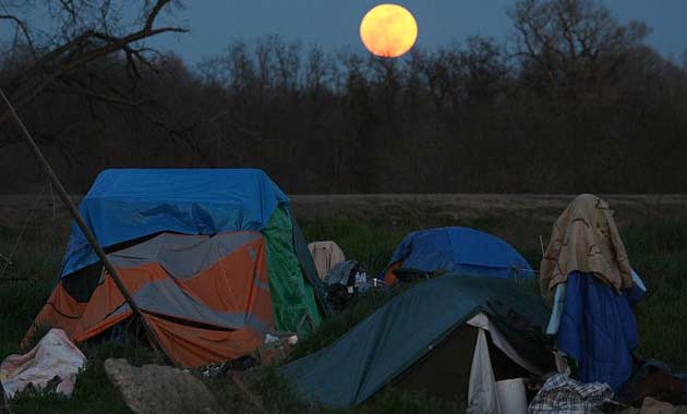 A full moon rises over Tent City