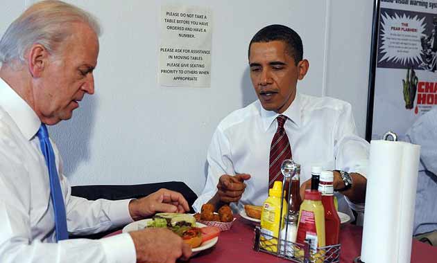 Barack Obama and Joe Biden eat their burgers