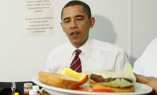 Barack Obama is served his cheeseburger at Ray's Hell Burger in Virginia