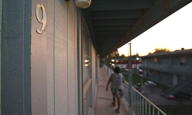 A neighbour walks past the residence of Nidal Hasan