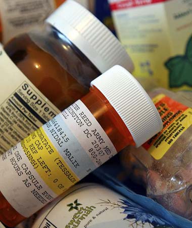 A box of prescriptions and supplements inside the apartment