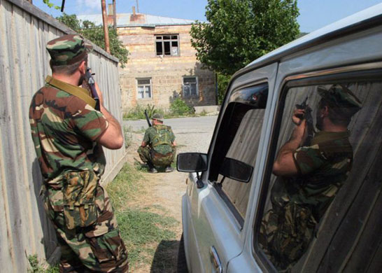 South Ossetian troops take cover