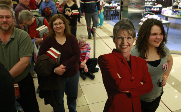 Fans queue to have their books signed, with a cutout Sarah Palin