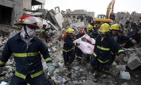 Iraqi rescue workers evacuate a body at the scene of a bomb blast in Baghdad