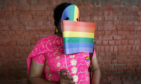 A gay rights activist displays a rainbow flag during 