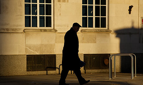 old man walking on an anonymous street 