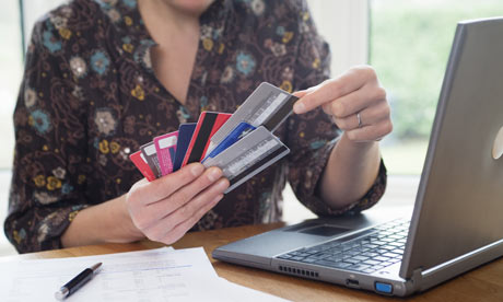 woman at desk choosing a credit card