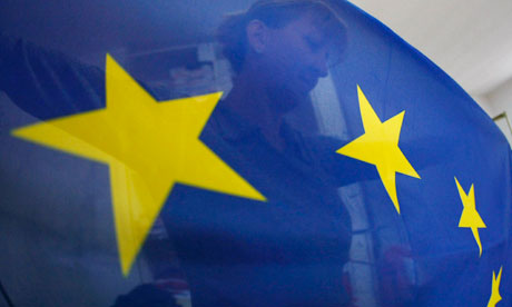 A seamstress sews a European Union (EU) flag in a small workshop in Belgrade