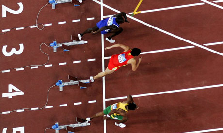 Athletes in the mens 110 metre hurdles sprint off the starting blocks
