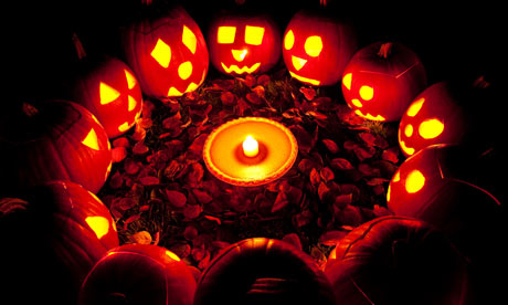 Carved pumpkins in a circle at twilight around a pumpkin pie on Halloween night