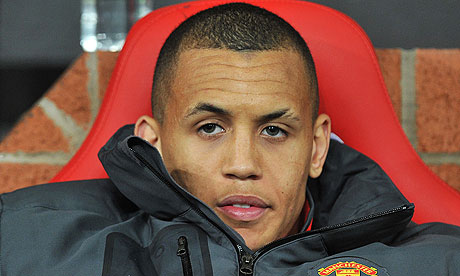 Ravel Morrison looks on from the team seats while Manchester United play.