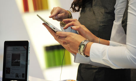 Two women try out an iPad during the 62n