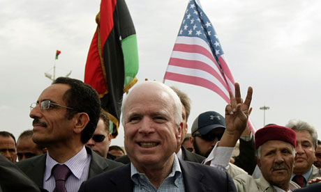 John McCain with US and Libya rebel flags behind him