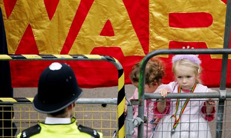 A policeman and two children at an anti-war protest