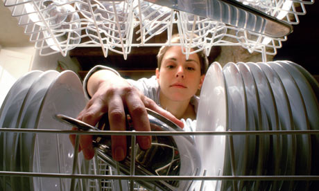 woman loads dishwasher