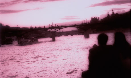 A couple look across the Seine