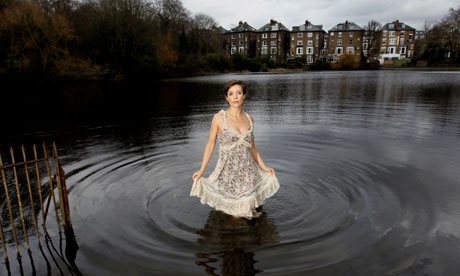 actor Lisa Dwan standing in a large pond