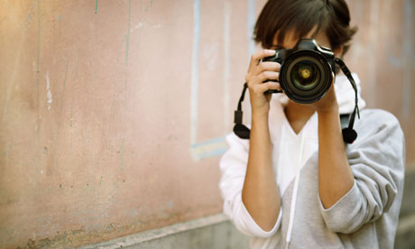 female photographer with professional SLR camera, 