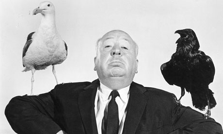 Alfred Hitchcock posing for the release of The Birds
