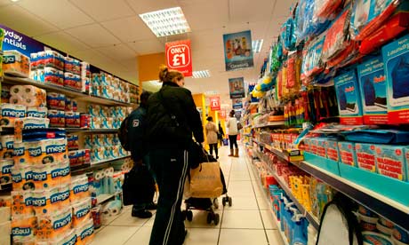 People wandering the aisles of a pound shop