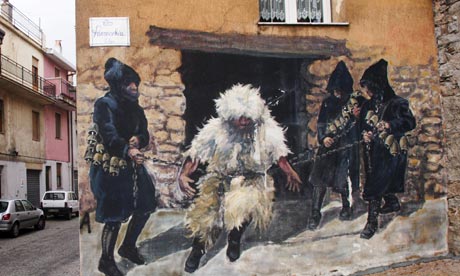 A mural on a wall in Sardinia shows a local bandit being captured.  John Borthwick