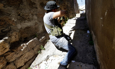 A Sunni gunman fires his AK-47