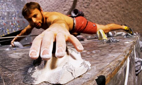 Wall climber reaches for a grip