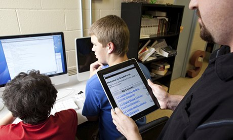 Teacher uses iPad during digital media literacy class at Manor New Tech High School in Manor, Texas