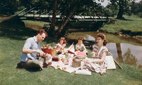 Family Having Picnic Beside Pond