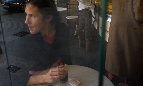 A woman drinking coffee in a cafe in Spain