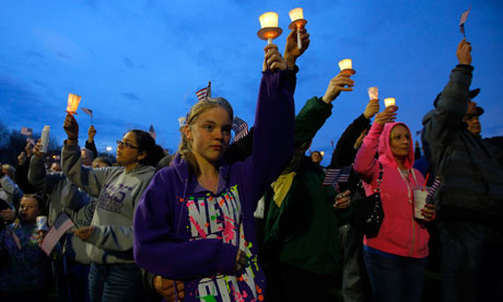 Local residents attend a candlelight vigil in the Dorchester neighborhood of Boston