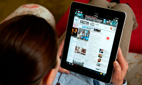 A woman using an iPad to read Russian