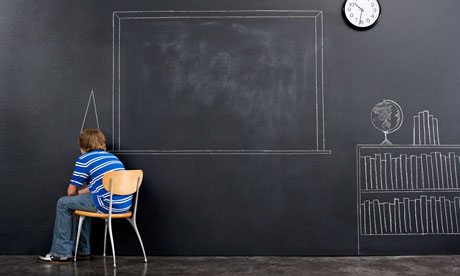 A boy sat in a corner with a chalk dunce cap