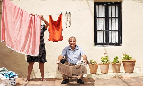 Couple on Patio with Newspaper and Laundry