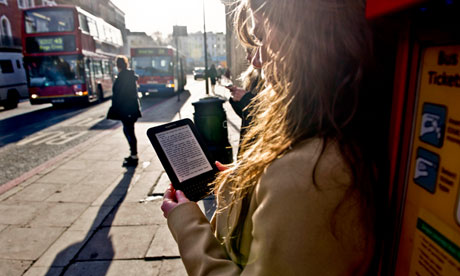 A woman with an e-reader on a London street