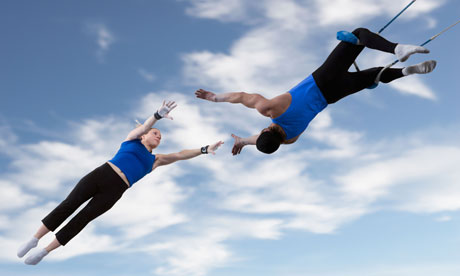 Acrobats catching each other in the air