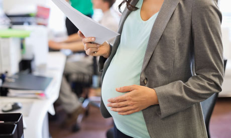 Pregnant businesswoman working in office. Image shot 2012. Exact date unknown.