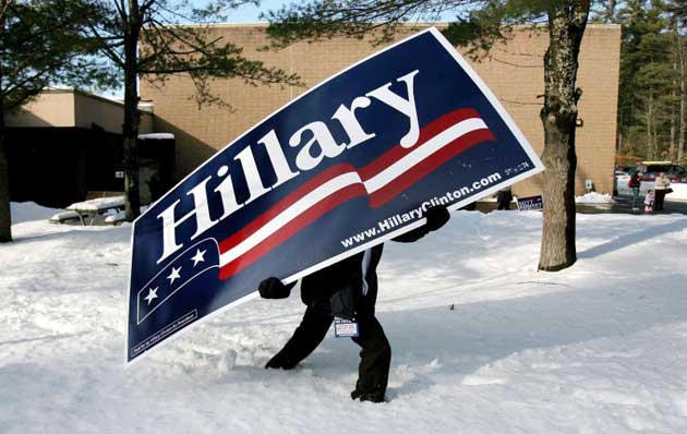 A man carries a sign for New York Senator and Democratic presidential hopeful Hillary Clinton through the sign before her arrival to a polling site at a school in Concord, New Hampshire, USA, 08 January 2008