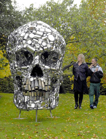  Visitors to the sculpture park of the Frieze Art Fair in Regents park in London, view Subodh Gupta's sculpture 