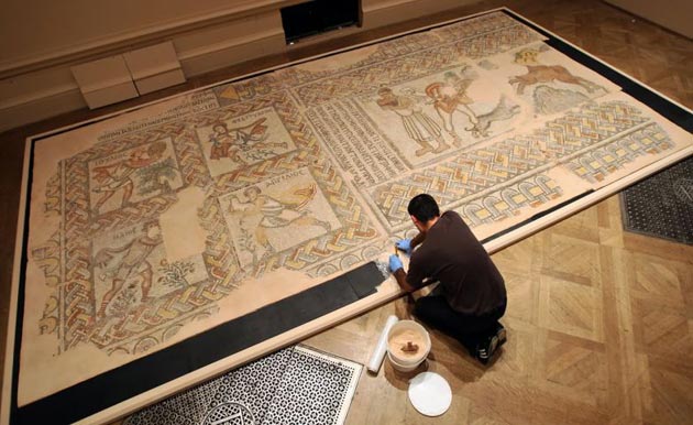 Byzantium at the Royal Academy:  A technician works on re-assembling part of a mosaic pavement with personifications of the months from the early sixth century