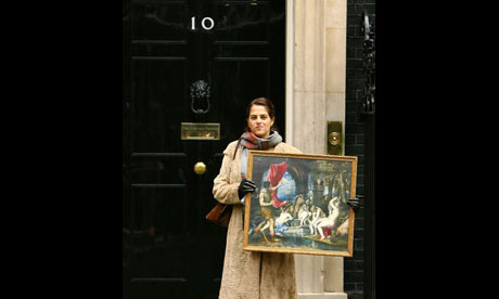Tracey Emin holds a reproduction of Titian's painting Diana and Actaeon on the steps of Number 10 Downing Street