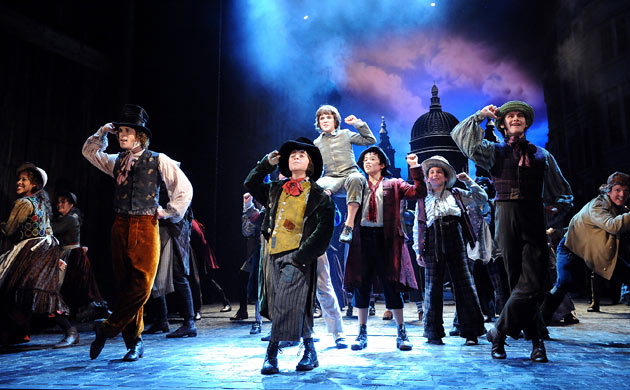 The cast of Oliver floods the stage at the Theatre Royal Drury Lane during 