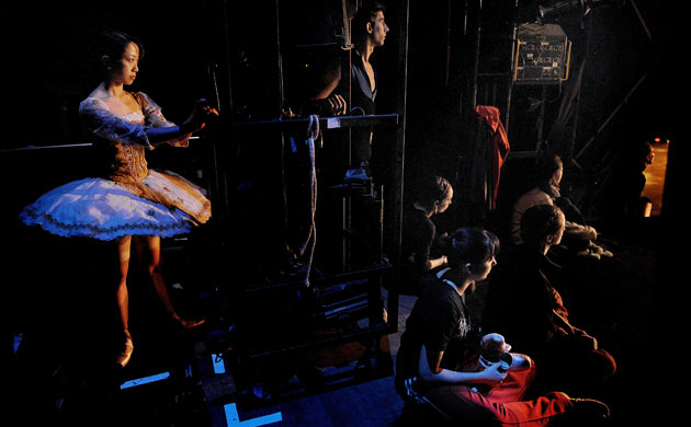 Dancers from the English National Ballet company in the wings during a rehearsal for Swan Lake