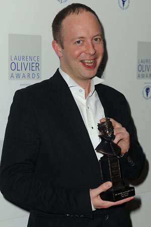 John Tiffany poses with the best director Olivier award for Black Watch