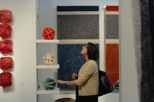 Week in art: Woman looking at decorative art, SOFA, New York, 2009