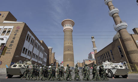 Security forces on patrol near a mosque in Urumqi.